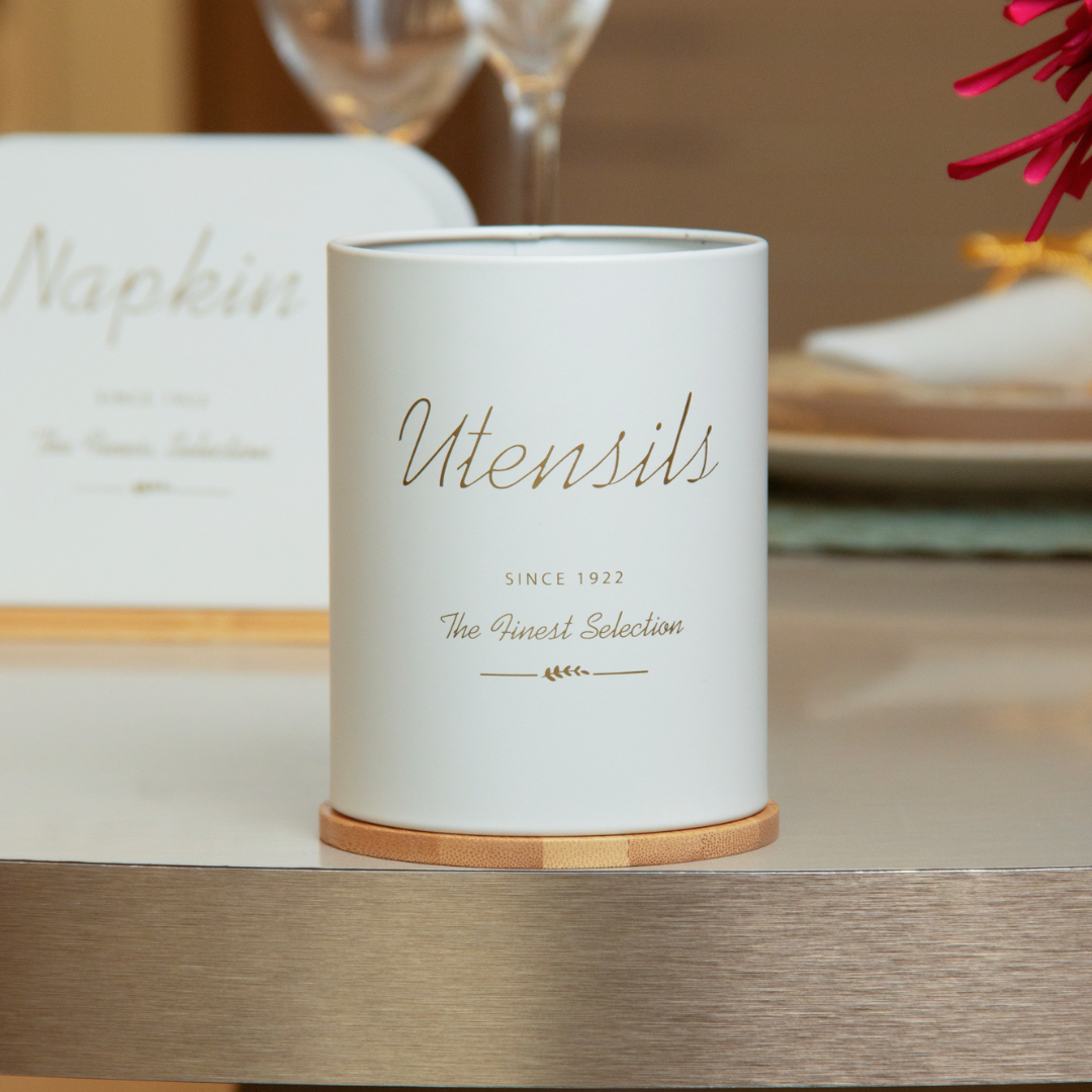 Porta utensílios cilíndrico branco com base madeira em mesa de jantar