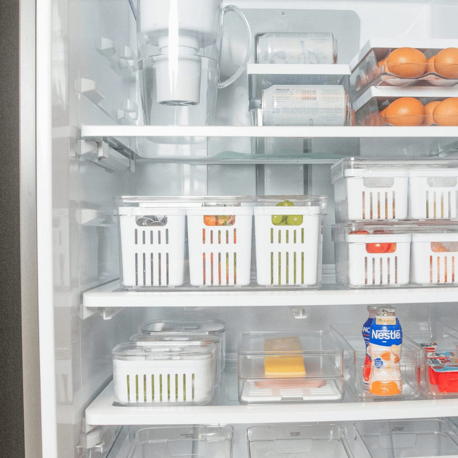 Interior de geladeira completamente organizado com múltiplos cestos e organizadores