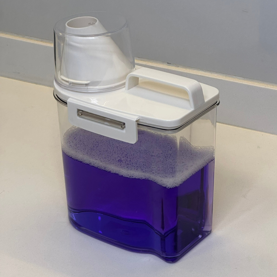 Pote transparente com liquido roxo e espuma mostrando versatilidade para produtos de limpeza